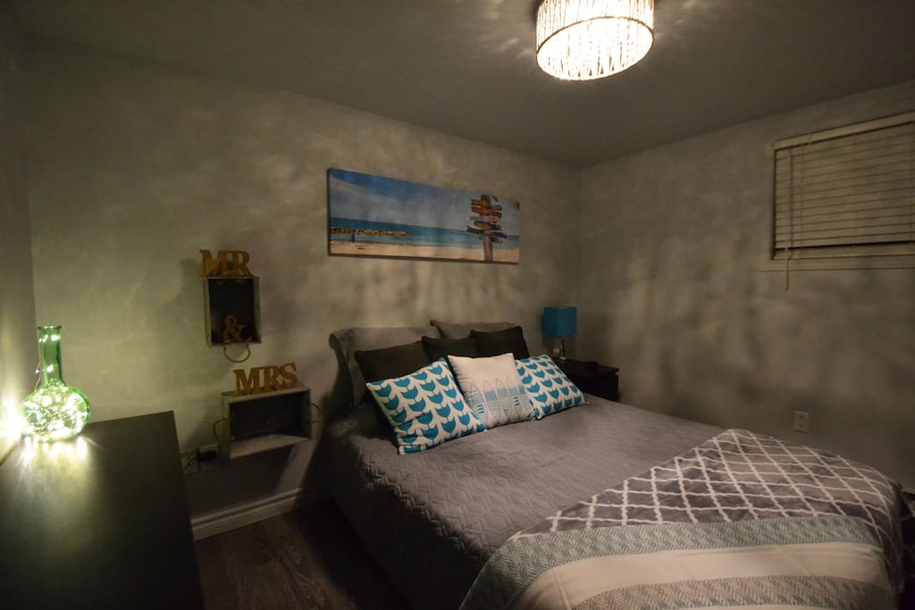 Bedroom with queen size bed and google mini