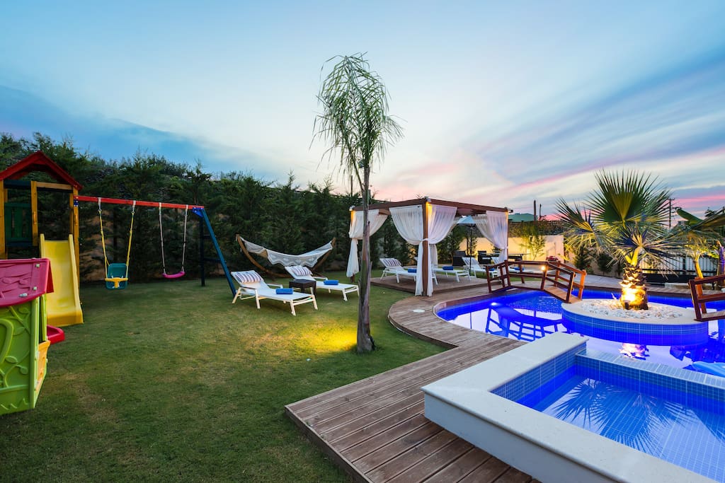 Lawn covered garden and wooden deck around the pool!