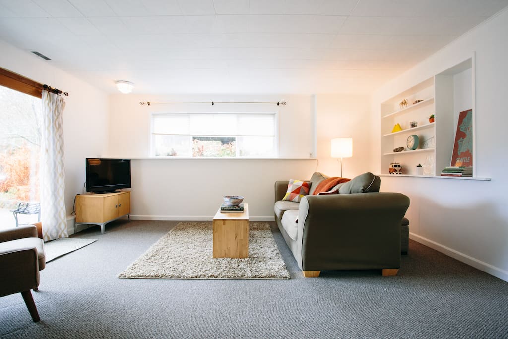Bright living room with high ceiling and roomy space to gather or get cozy