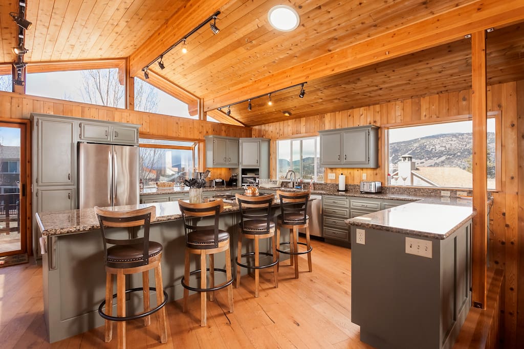 Kitchen with Expansive Granite; Bar Stool Seating and New Wood Floors