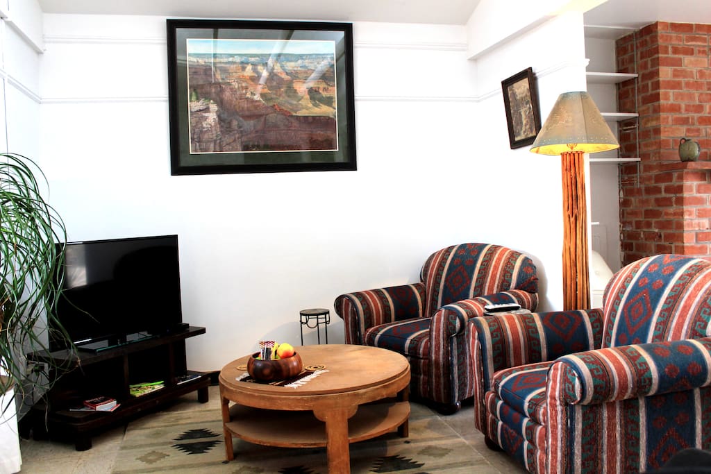 Living room sitting area of guest house with the TV on the left.