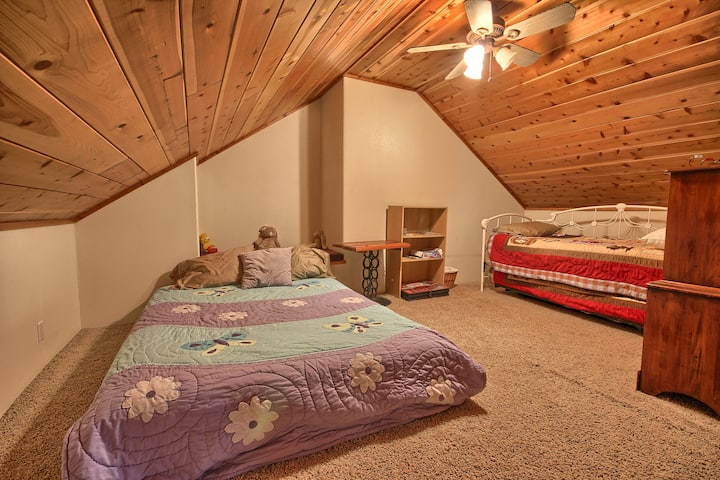 Sleeping loft with queen mattress and trundle bed.