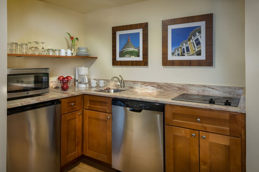 Newly renovated kitchenette has refrigerator, dishwasher and cook top.
