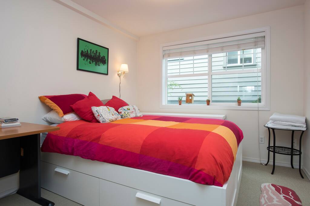 Your room, with your queen-sized bed, desk, and fresh towels.