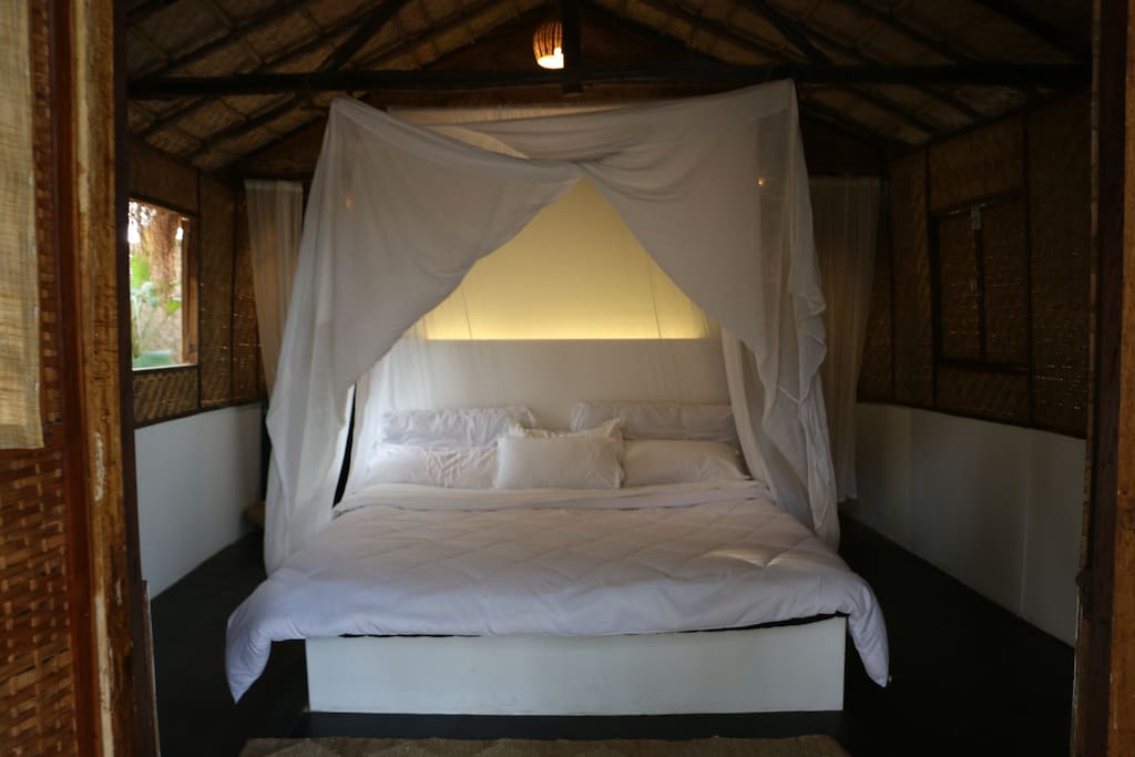 BedroomThe Bedroom with High Quality Supersoft Mattress and Bed Linen, Along with Mosquito Net, JutexHemp Rugs to ensure the most comfortable sleep