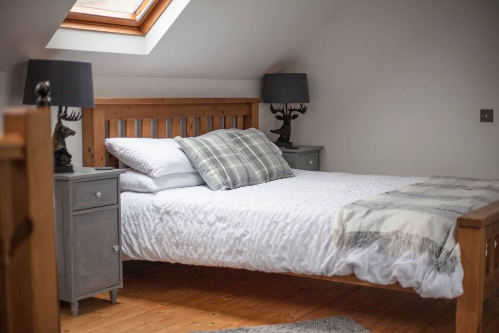 Comfortable King Size bed in the upstairs of The Barn. Fantastic views of the local mountains. Black out blinds in sky lights.