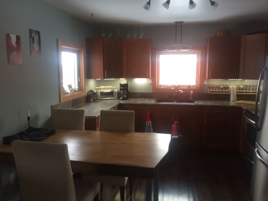 Fully equipped kitchen with modern appliances (including dishwasher) and hand made, locally milled wooden table.