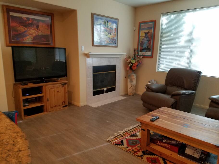 Fireplace, couch, and recliners in living room