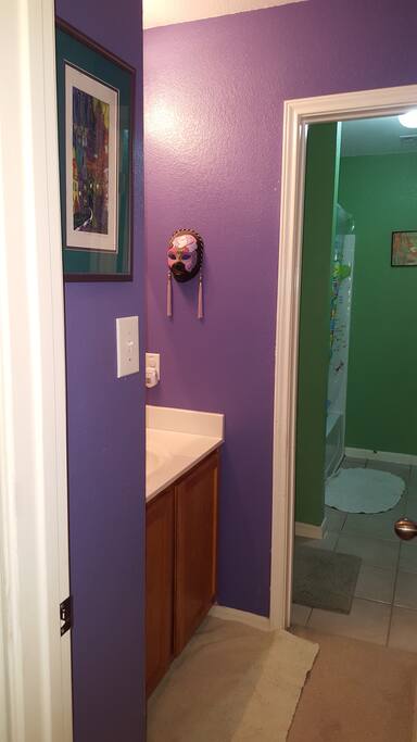 Convenient - and private - "Jack & Jill" bathroom with purple sink area is separated by a locking door from the green, map-filled shower/toilet room.
(Note: This bathroom is shared with guest(s) staying in the Sky Room.)