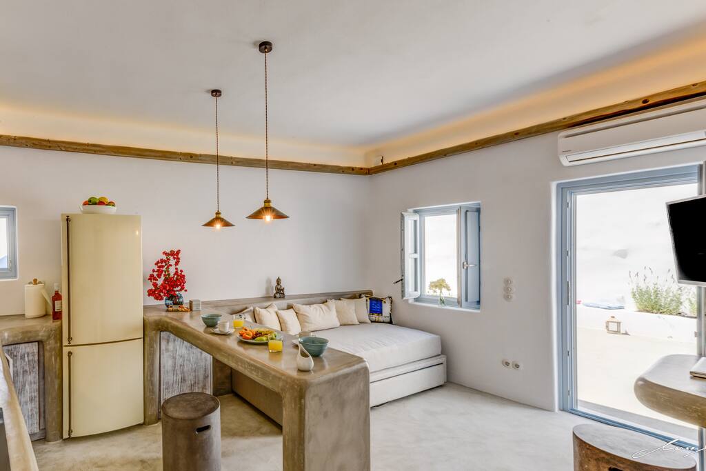 More living room /kitchen featuring sofa bed that could sleep two