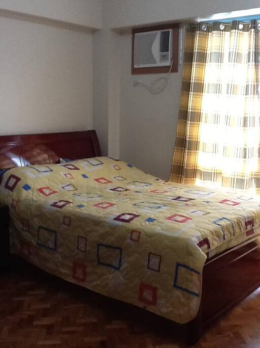 Masters Bedroom has 1 Queen Mahogany Bed overlooking City Skyline.