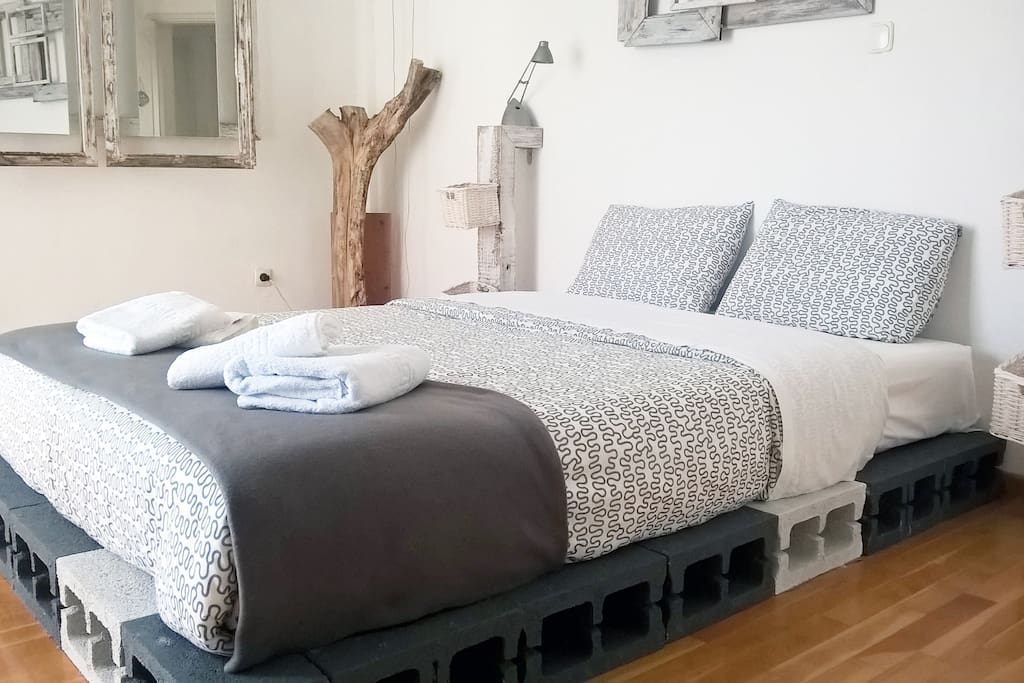 A different bedroom experience, for sure. Featuring a wooden floor, a large three-piece mirror made from recyclable materials and artwork that are as quirky as its owner.