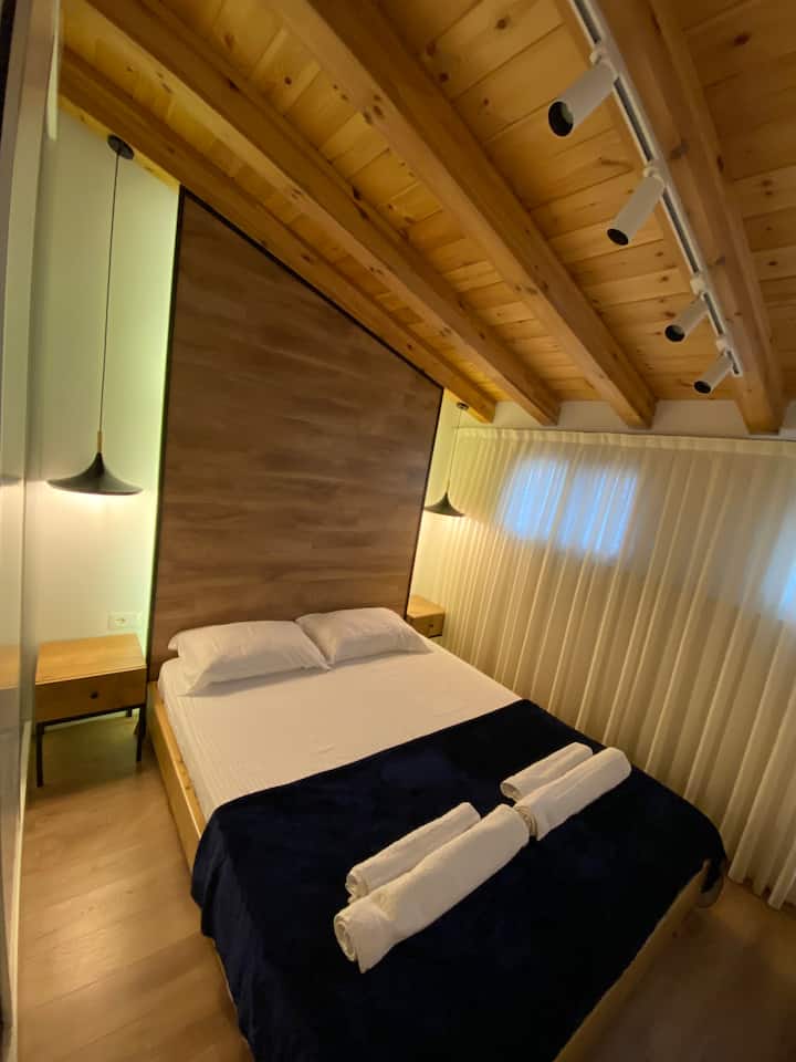 The bedroom is decorated with wood and the bed is very comfortable.