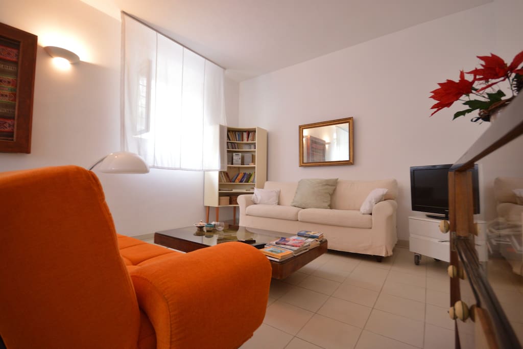 the Living Room, the orange sofa become a bed for 2 and the white sofa a single bed