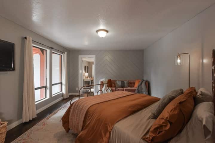First floor Bedroom 4.  Two seating areas.  Queen bed. Plus fold down sofa.