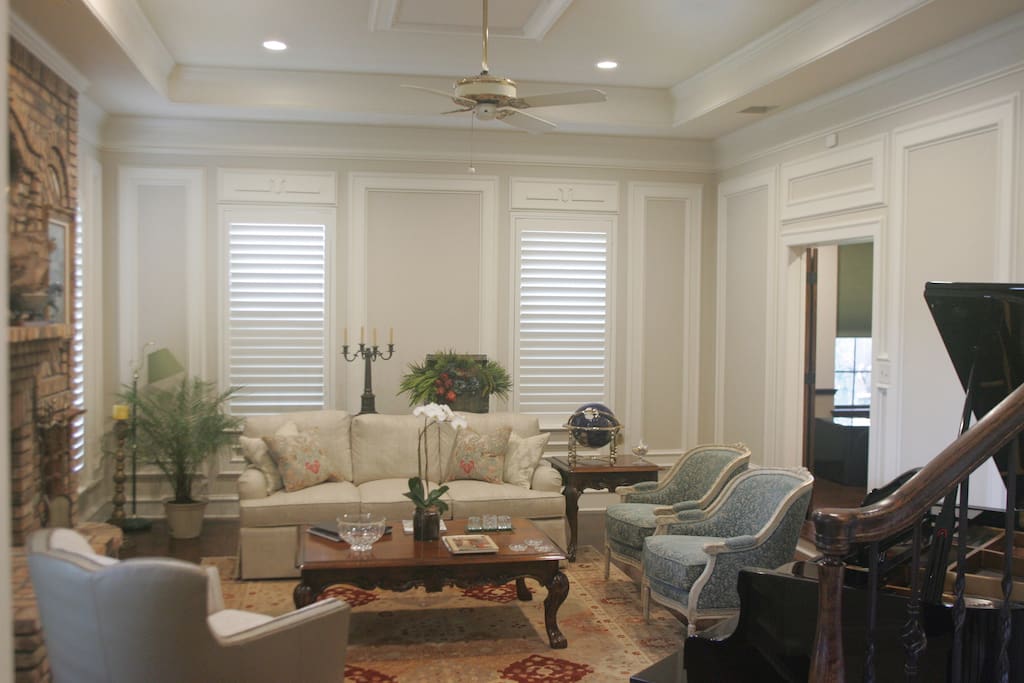 Formal Living area with Grand Piano, luxurious seating around the custom brick fireplace!