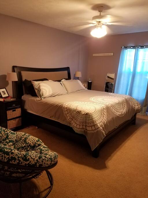 Inviting master bedroom with seating and a tv!