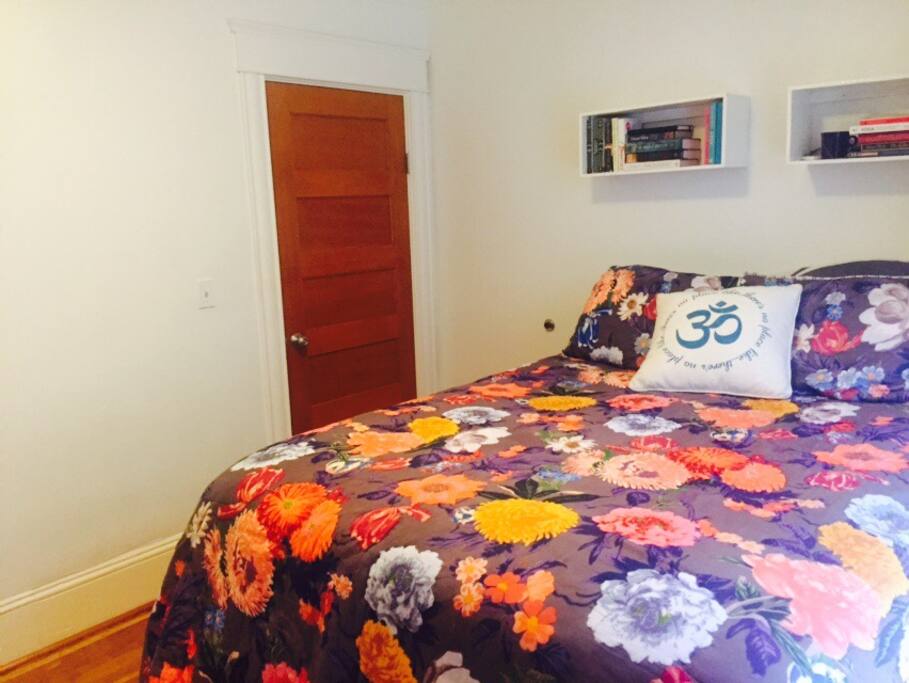 Queen bed with tons of pillows and blankets.