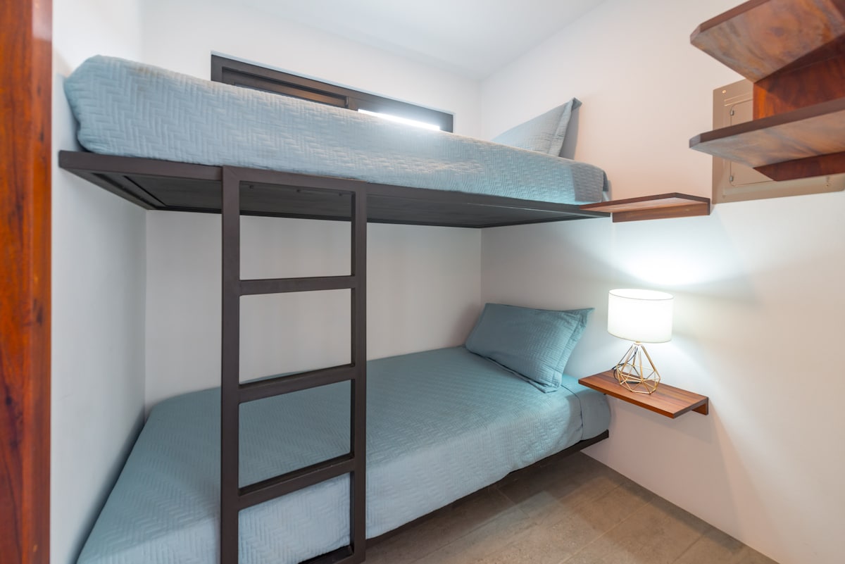 Bunk beds in the downstairs bedroom ensuite to a bathroom.