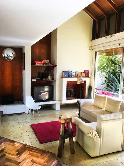 Living con piso parquét y ceramica. Amplios ventanales y espacios verdes.