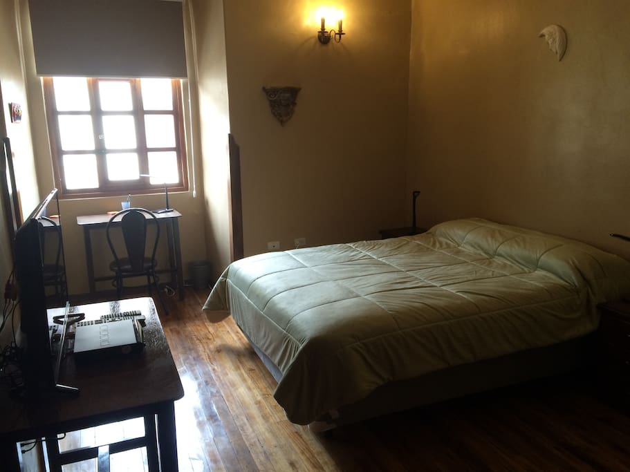 Queen bed with reading lamps on both sides.