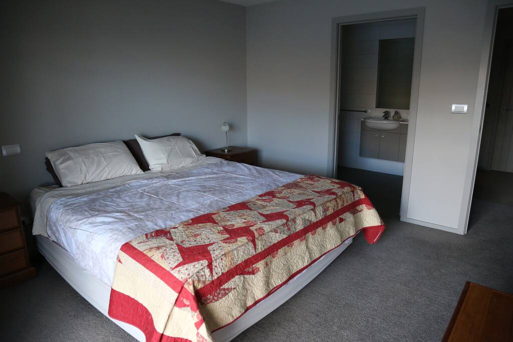 Your bed, looking into your private bathroom.