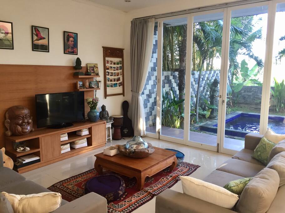 The lounge room, with bifold doors opening up to the pool area.