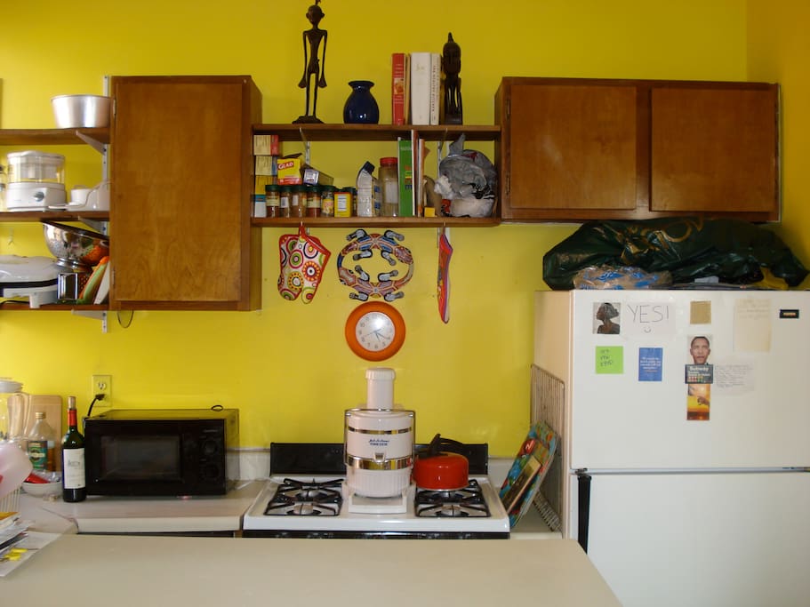 Kitchen: Microwave, stove, refrigerator, cabinets, sink, counter top, window. Next to living room.