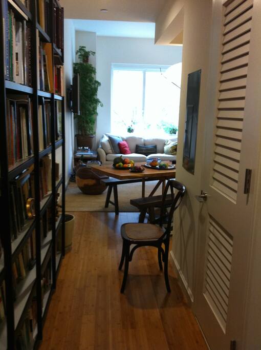 Entry into apartment with bookshelves..another coat closet to right not show, other closet has washer and dryer