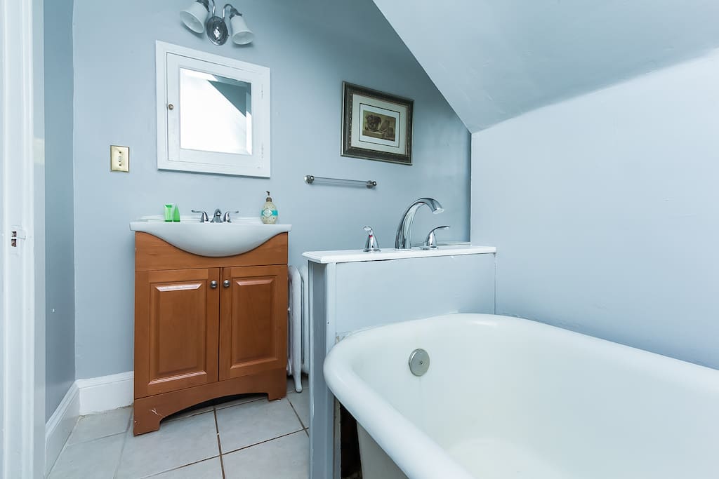 Bright bathroom with just tub no shower