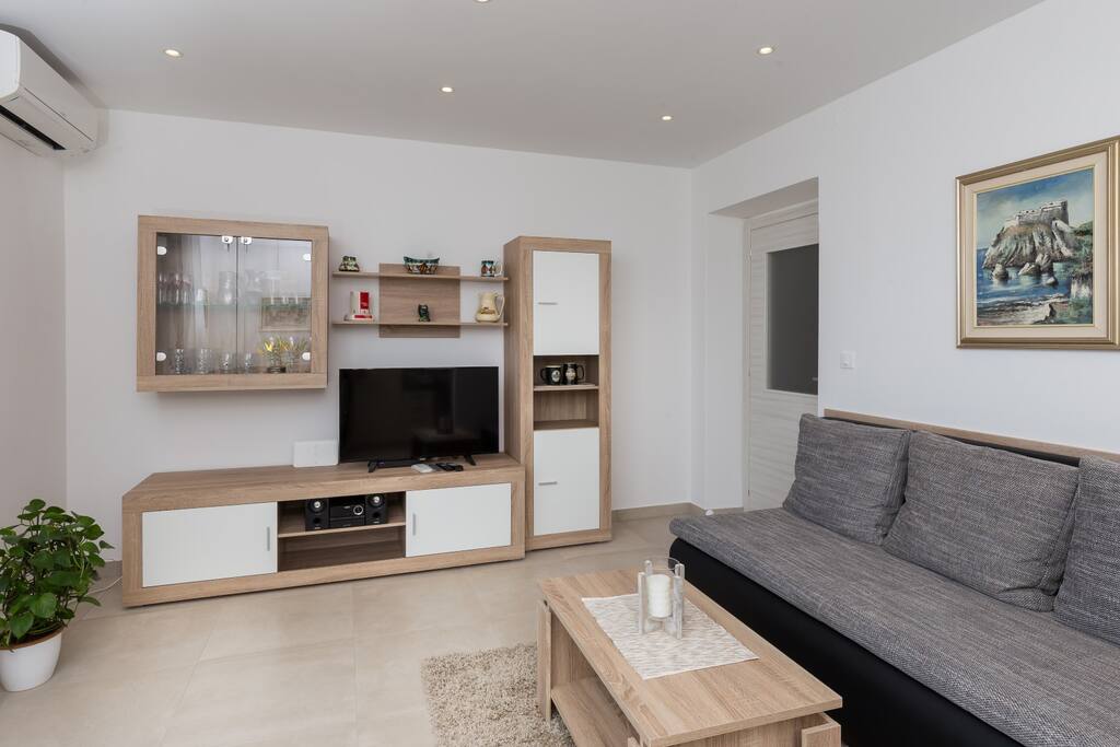 Bright and spacious living room with couch that turns into a King size bed in seconds...