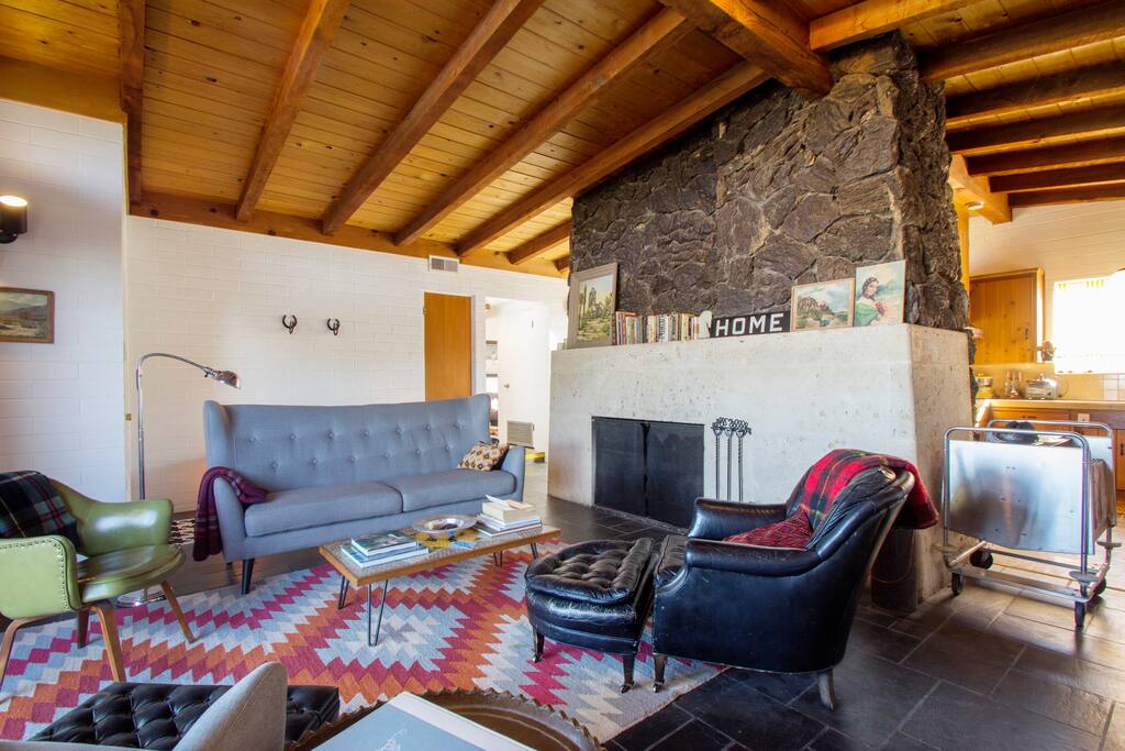 Exposed beams and massive lava rock and Texas limestone fireplace in the living room.