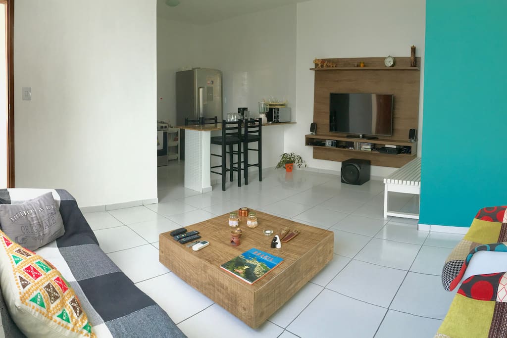 The open living room also with air-conditioning and well equipped digital entertainment system, cable TV, a PS3, reclinable sofa and open kitchen.