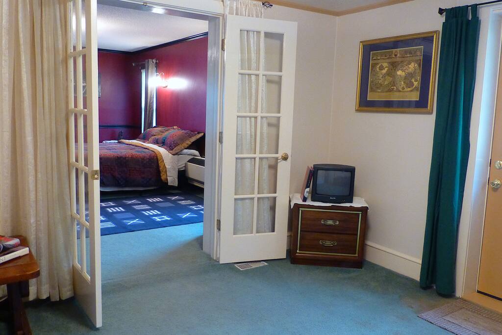 Bright, well lit reading room looking into master bedroom.