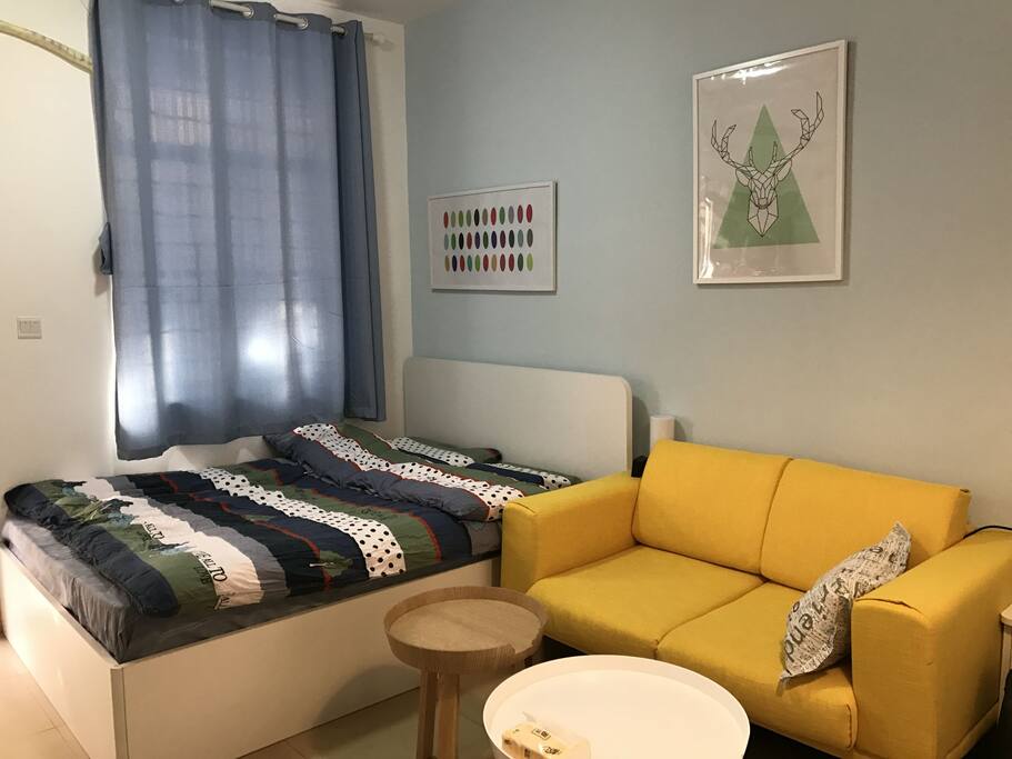 Queen bed and sofa with lots of daylight