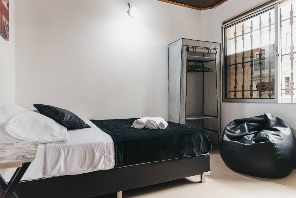 Your private bedroom with double bed, desk/workspace, closet, lamp, night stand.