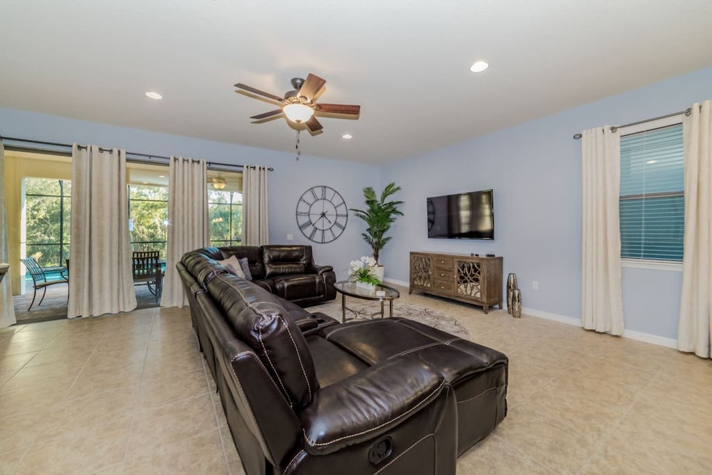 Living room with leather sectional sofa and flat screen TV