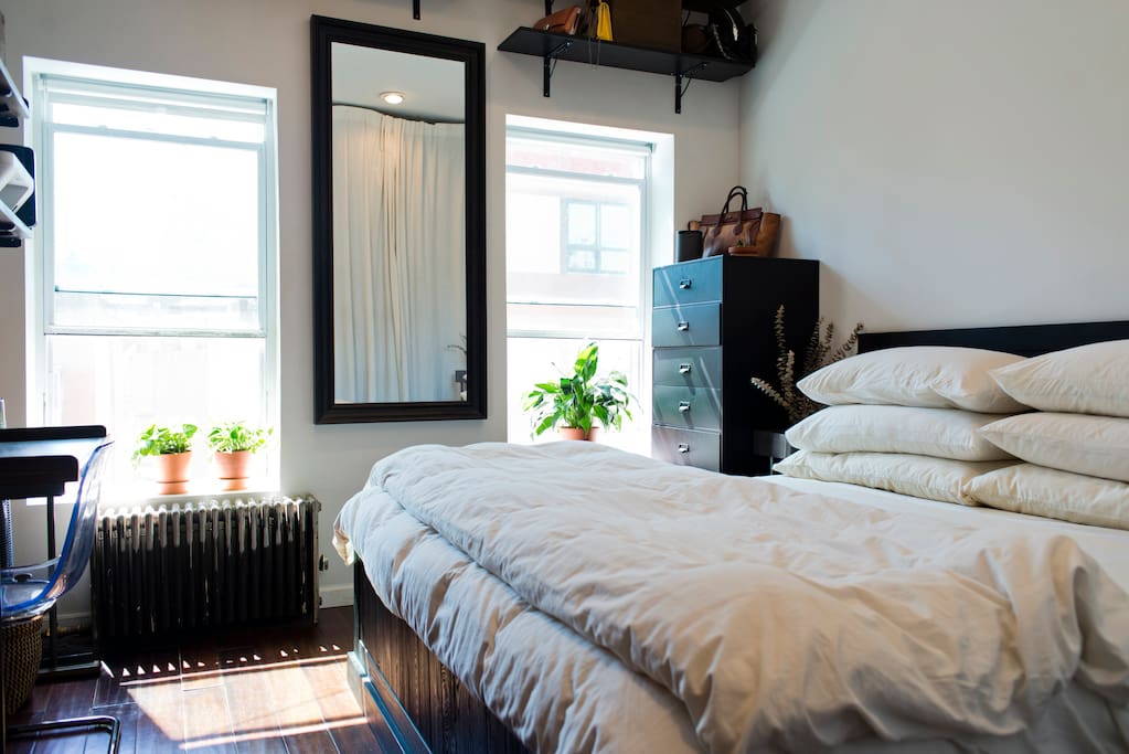 Master bedroom with king sized bed and a desk