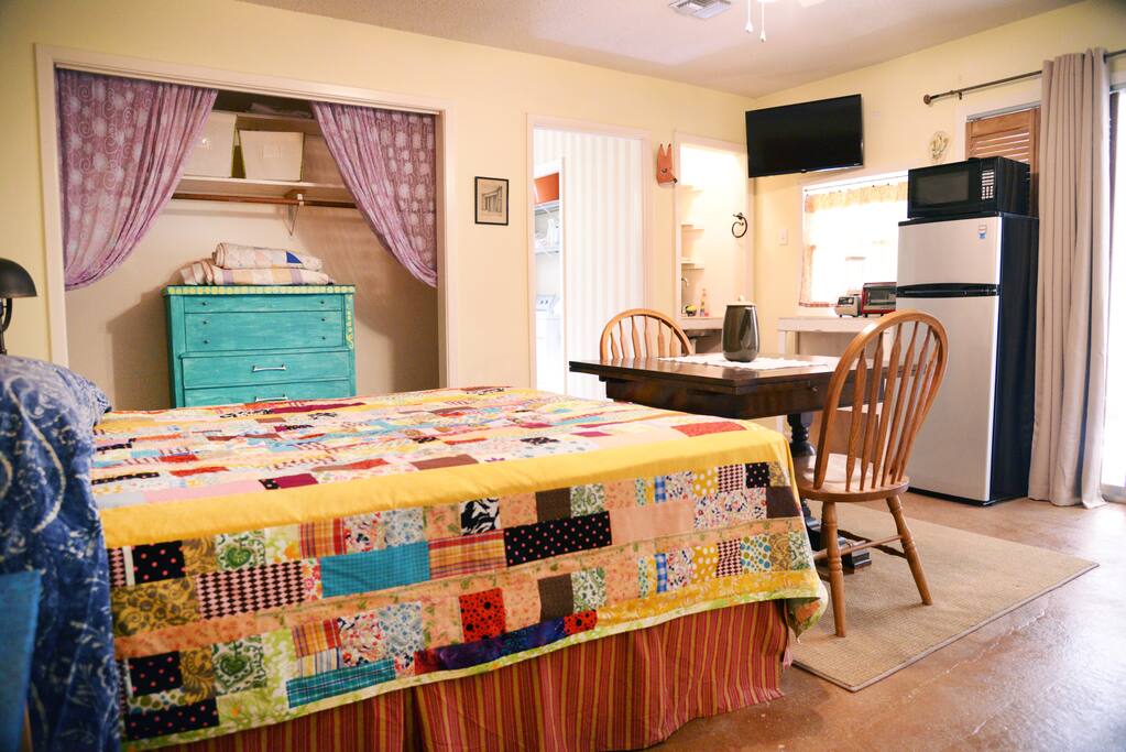 Another view featuring the kitchenette, table and chairs and spacious closet