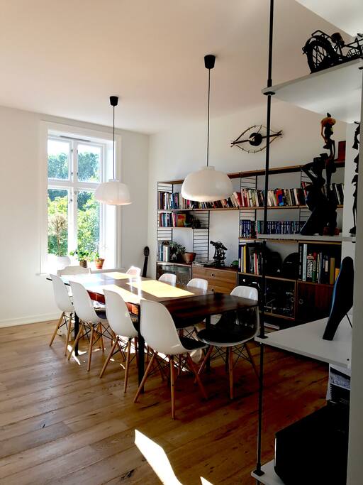 Spacious dining area joined to living room with fireplace
