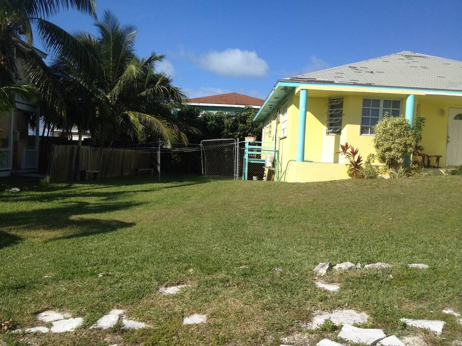 Large yard space and kitchen door steps at the side of the house.