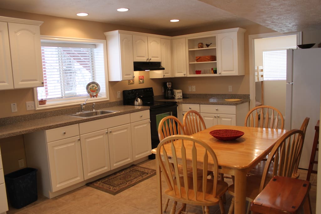 Spacious kitchen area with full fridge and oven/range.