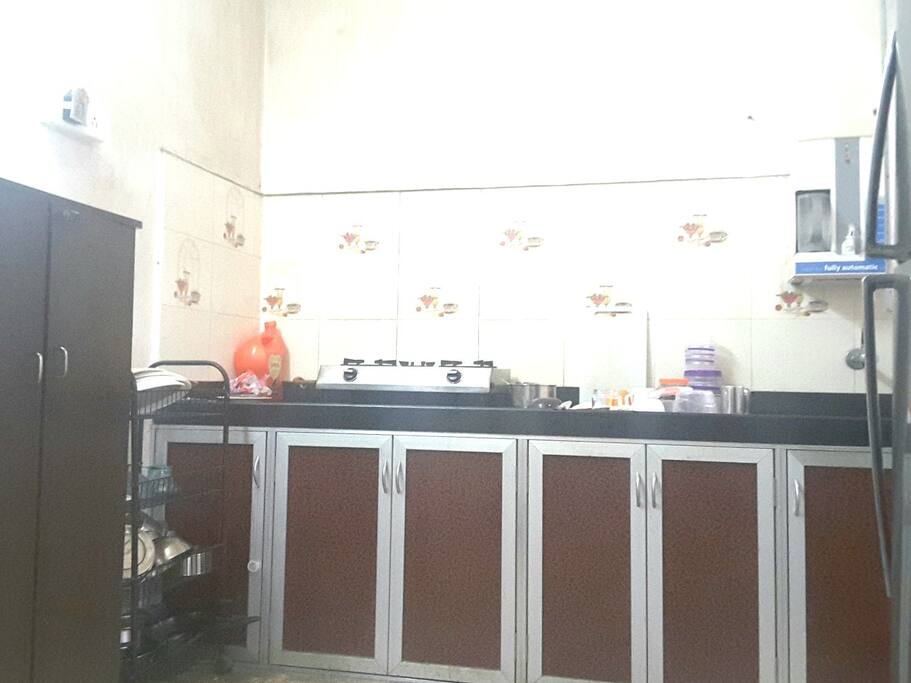 Fully furnished kitchen for cooking.