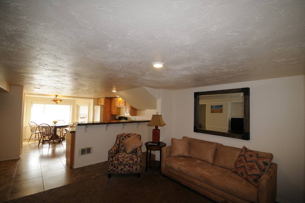 Main living area looking into fully equipped eat-in kitchen