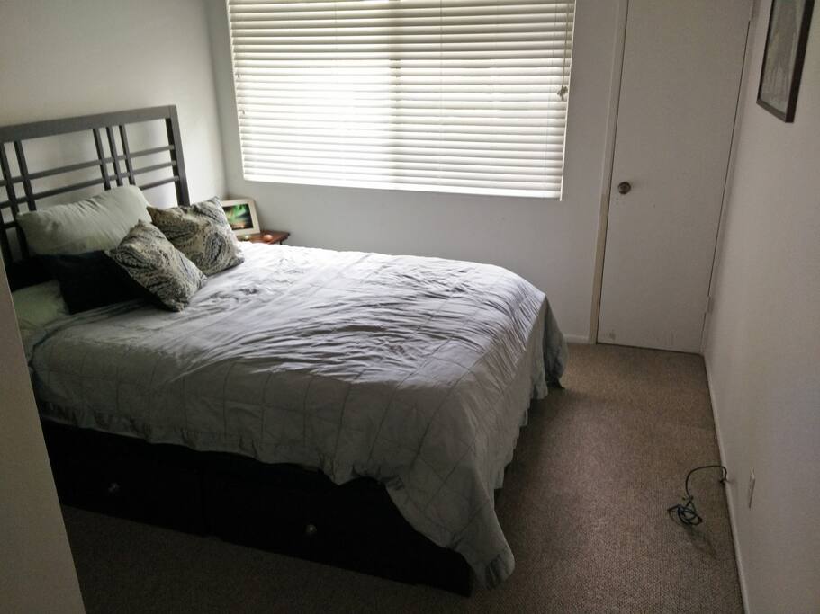 the guest bed room is a very comfy queen bed with high thread count sheets and plenty of pillows