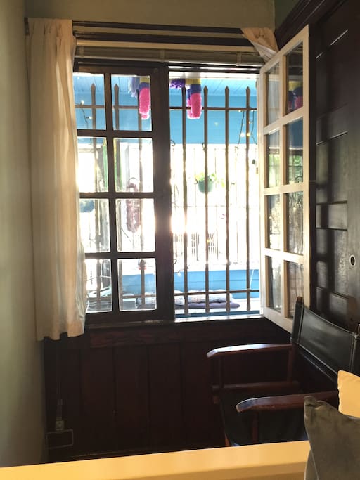 Little sitting area with great filtered sunshine overlooking the porch and classic Venice street beyond