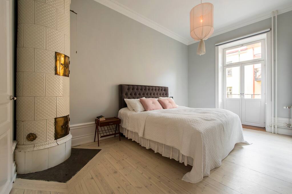 Master bedroom with working fireplace and balcony.