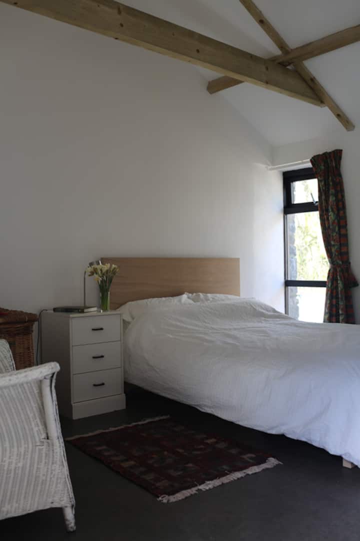 Dvokrevetna spavaća soba s prozorom koji gleda niz stazu