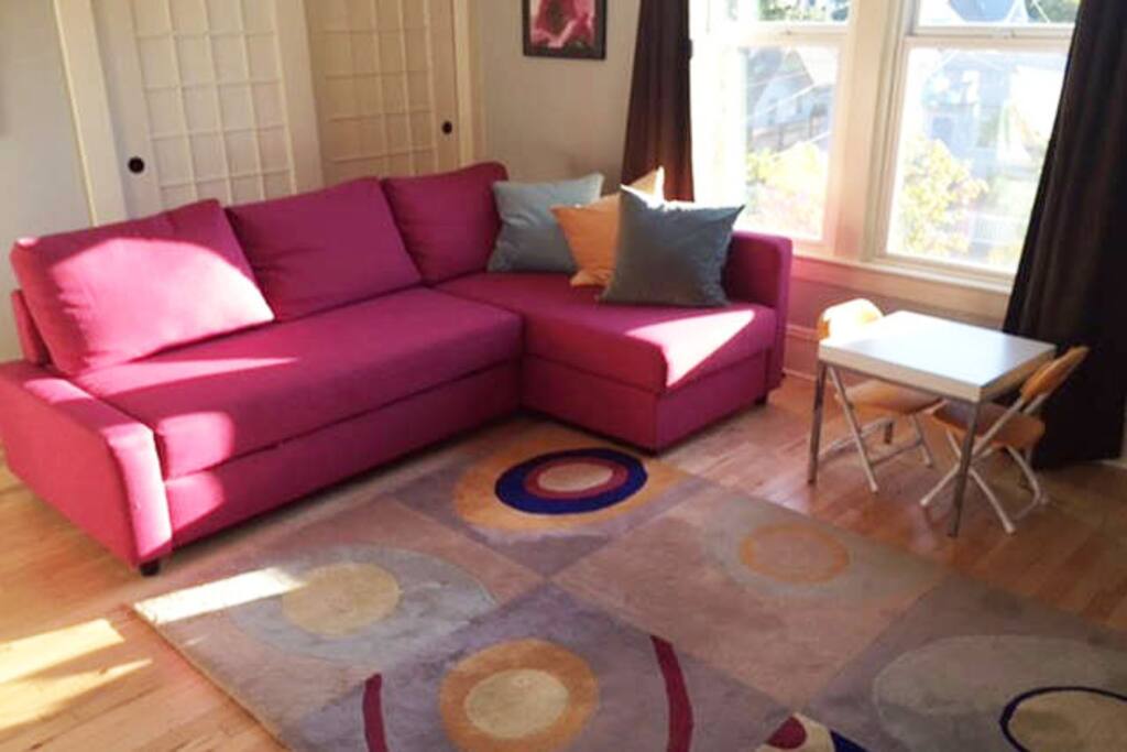 Large living room windows let in lots of light and air.