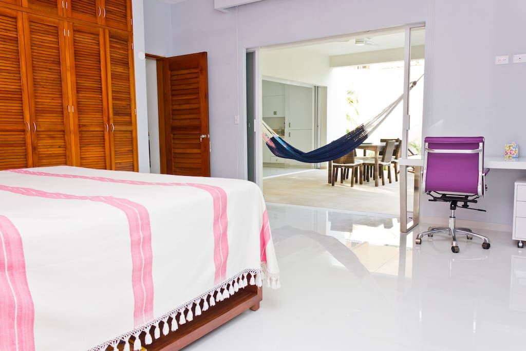 Another view of the master bedroom with king-sized bed and spacious closet space.